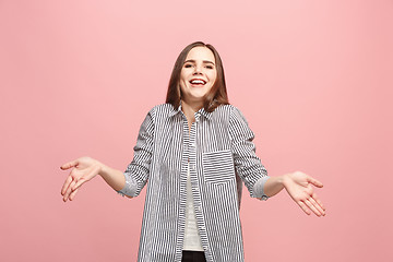 Image showing Beautiful female half-length portrait isolated on pink studio backgroud. The young emotional surprised woman