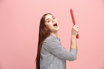 Image showing Businesswoman hugging laptop on pink studio