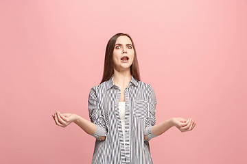 Image showing Beautiful female half-length portrait isolated on pink studio backgroud. The young emotional surprised woman