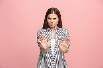 Image showing Let me think. Doubtful pensive woman with thoughtful expression making choice against pink background