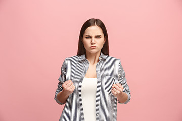 Image showing Portrait of an angry woman looking at camera isolated on a pink background