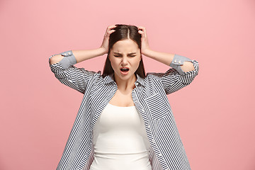 Image showing Woman having headache. Isolated over pastel background.