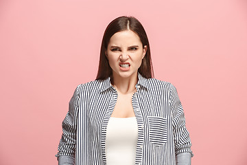 Image showing Portrait of an angry woman looking at camera isolated on a pink background