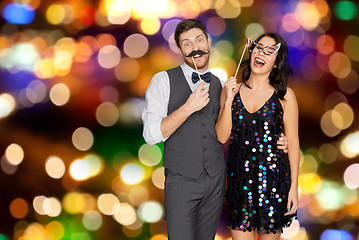 Image showing happy couple with party props having fun