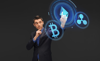 Image showing businessman with cryptocurrency holograms