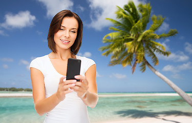 Image showing woman taking selfie by smartphone on beach