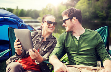 Image showing happy couple with tablet pc at camping tent