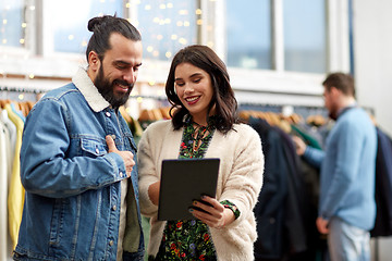 Image showing couple with tablet pc at vintage clothing store