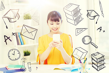 Image showing happy young woman student with smartphone at home