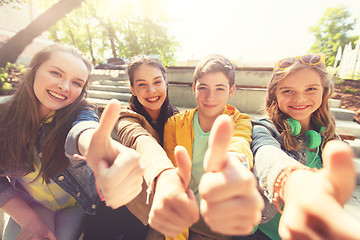Image showing teenage friends or students showing thumbs up