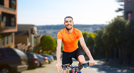 Image showing happy man riding bicycle over san francisco city