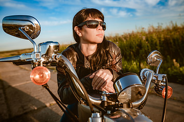 Image showing Biker girl sitting on motorcycle