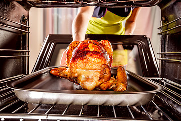 Image showing Cooking chicken in the oven at home.