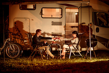 Image showing Adult couple clinking glasses of wine. Family vacation travel RV