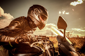 Image showing Biker racing on the road