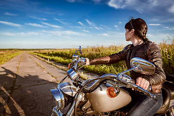 Image showing Biker girl sitting on motorcycle