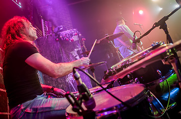 Image showing Drummer playing on drum set on stage.