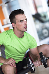 Image showing handsome man working out with dumbbells