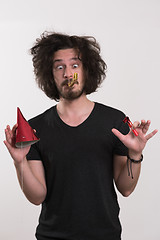 Image showing Portrait of a man in party hat blowing in whistle