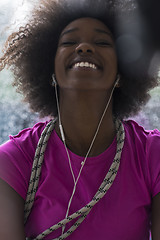 Image showing portrait of young afro american woman in gym while listening mus