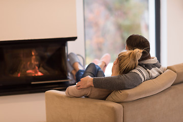 Image showing Young couple  in front of fireplace