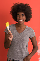 Image showing black woman painting wall