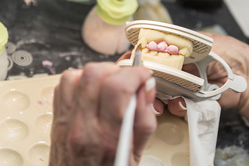 Image showing Dental Technician Applying Porcelain To 3D Printed Implant Mold