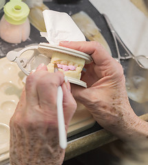 Image showing Dental Technician Applying Porcelain To 3D Printed Implant Mold