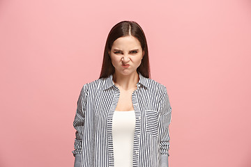 Image showing Portrait of an angry woman looking at camera isolated on a pink background