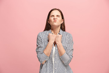 Image showing Portrait of an angry woman looking at camera isolated on a pink background