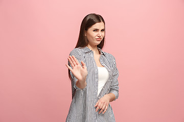 Image showing Let me think. Doubtful pensive woman with thoughtful expression making choice against pink background