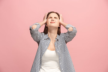 Image showing Woman having headache. Isolated over pastel background.