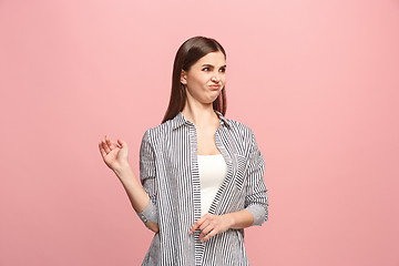 Image showing Young woman with disgusted expression repulsing something, isolated on the pink