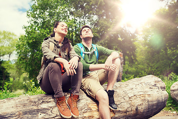 Image showing smiling couple with backpacks in nature