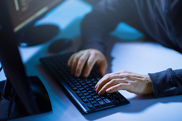 Image showing hacker hands typing on computer keyboard