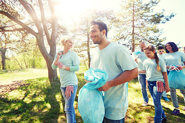 Image showing volunteers with garbage bags walking outdoors