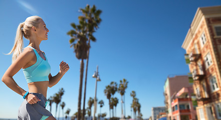 Image showing woman with fitness tracker running