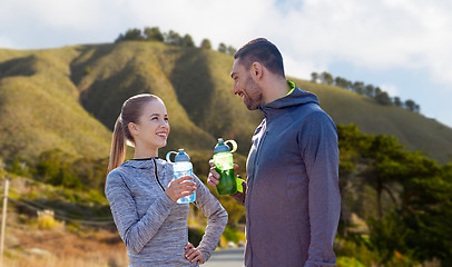 Image showing couple of sportsmen with water over big sur hills