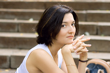 Image showing pretty woman sitting on a staircase