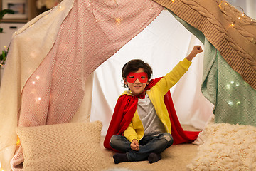 Image showing happy boy in super hero stuff in kids tent at home