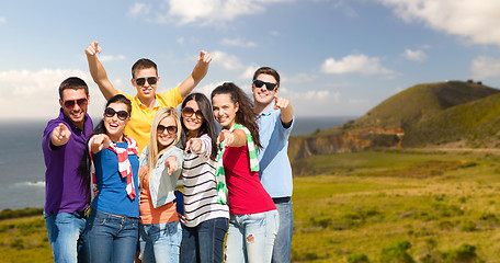 Image showing happy friends pointing at you over big sur coast