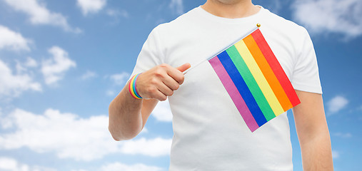 Image showing man with gay pride rainbow flag and wristband