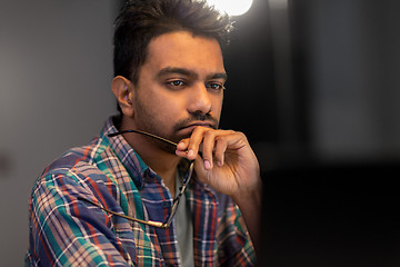 Image showing close up of creative man working at night office