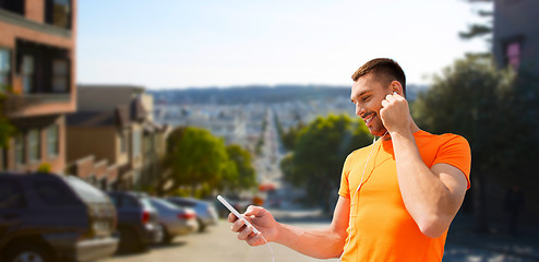 Image showing man with smartphone and earphones in san francisco