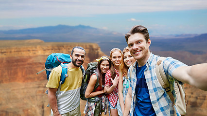 Image showing happy travelers taking selfie at grand canyon