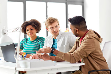 Image showing happy creative workers with laptops at office