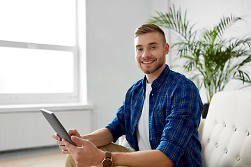 Image showing happy smiling man with tablet pc at office