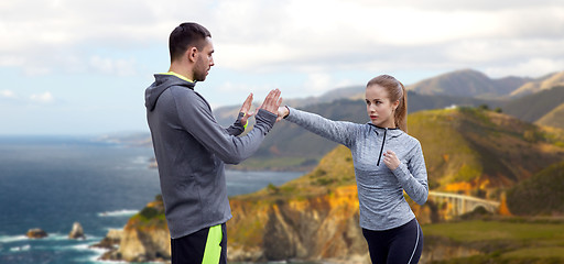 Image showing happy woman with coach working on strike outdoors