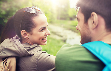 Image showing smiling couple with backpacks in nature