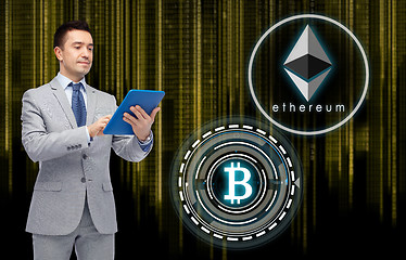 Image showing businessman with tablet pc and cryptocurrency